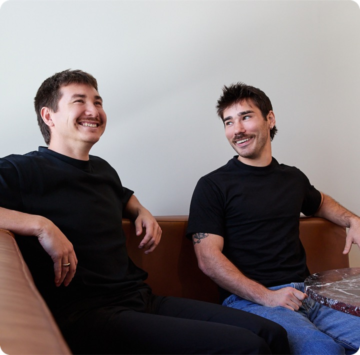 Aidan Lambert and Caleb Harward, the founders of Better Automations, sitting and laughing during a working session